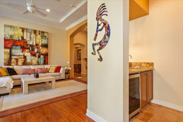 a living room with furniture a rug and a wall painting