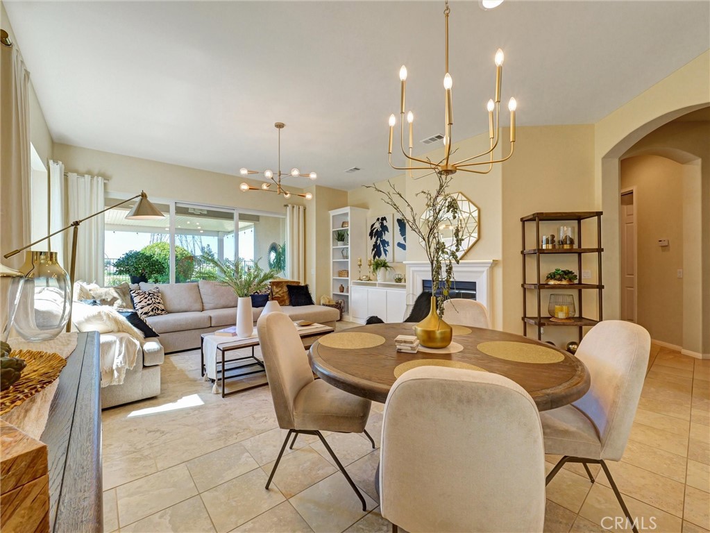 887 Westchester Road Beaumont, CA 92223 - Photo 15 of 41 a living room with furniture a chandelier and a large mirror