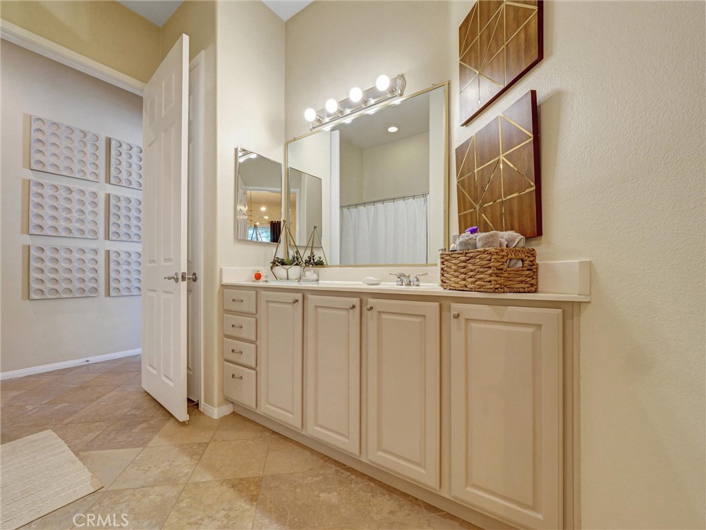 887 Westchester Road Beaumont, CA 92223 - Photo 23 of 41 a bathroom with a sink and a mirror
