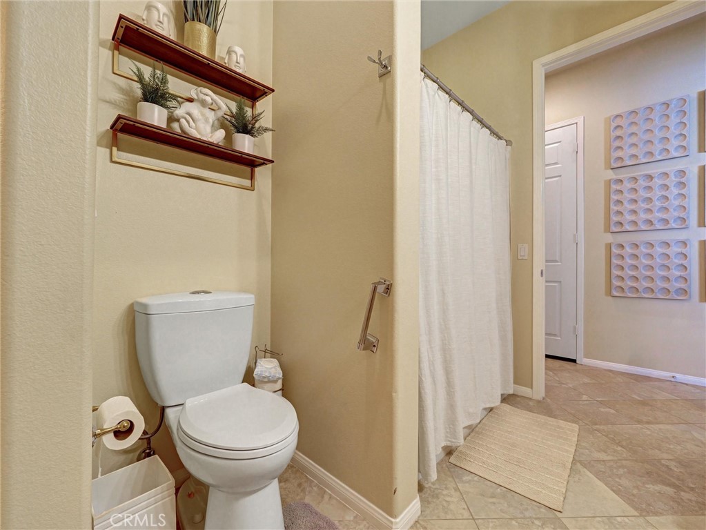 887 Westchester Road Beaumont, CA 92223 - Photo 24 of 41 a bathroom with a toilet and a shower