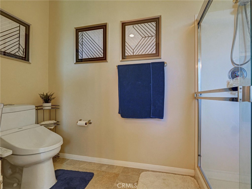 887 Westchester Road Beaumont, CA 92223 - Photo 32 of 41 a bathroom with a toilet and a shower