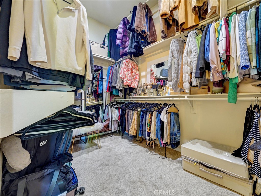 887 Westchester Road Beaumont, CA 92223 - Photo 34 of 41 a view of walk in closet with clothes and shoes