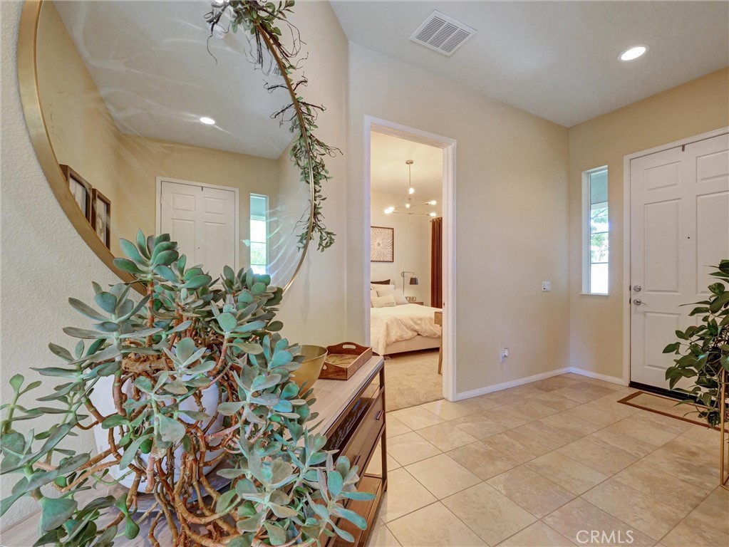 887 Westchester Road Beaumont, CA 92223 - Photo 4 of 41 wooden floor with a potted plant and a large mirror