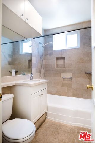 a bathroom with a sink a toilet and bathtub