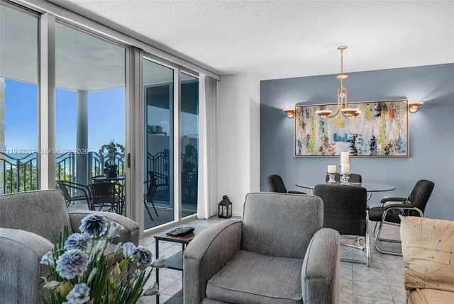 a living room with furniture and a chandelier