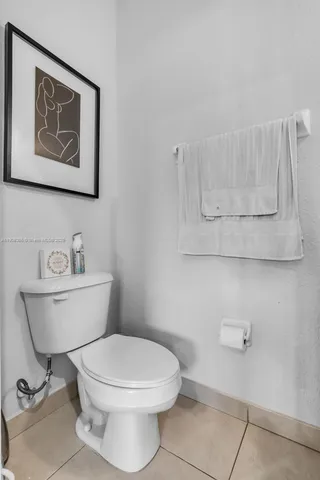 a white toilet sitting next to a bathroom sink and tub