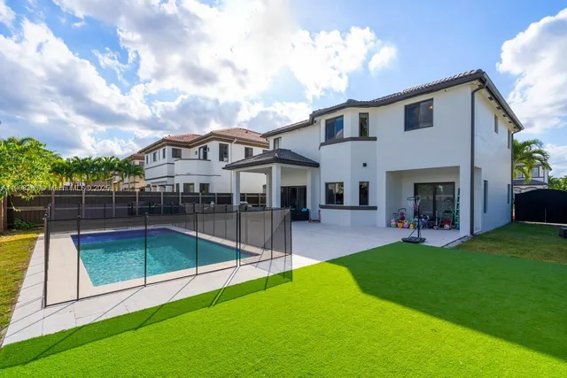 a view of a house with a backyard porch and sitting area