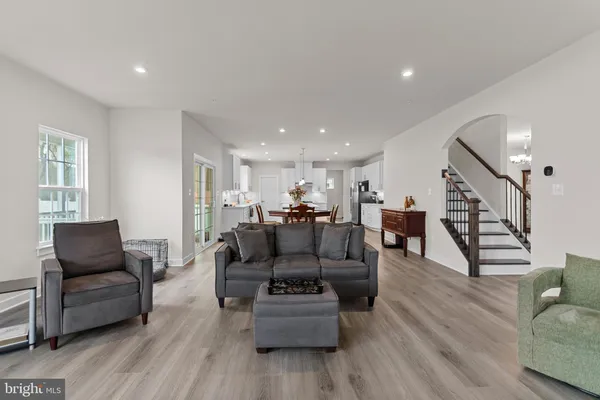 a view of a hallway with wooden floor and stairs