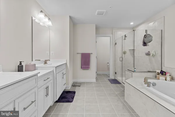 a bathroom with a tub a sink and a window