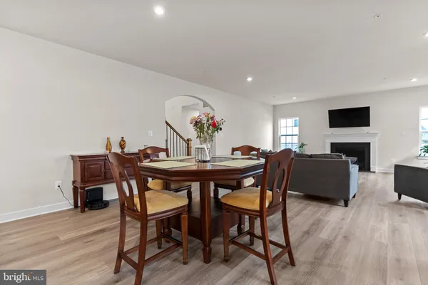 a living room with furniture a fireplace a flat screen tv and a window