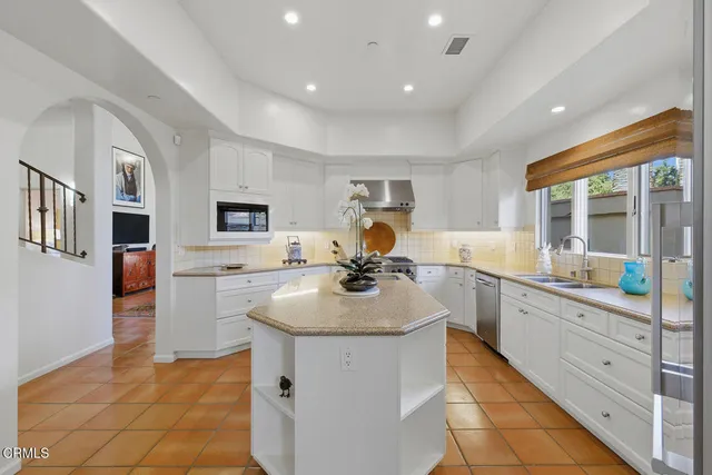 a kitchen with sink cabinets and window