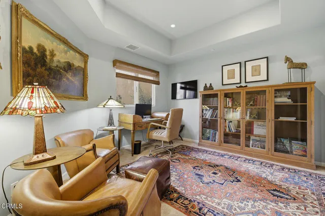 a living room with furniture a window and a flat screen tv
