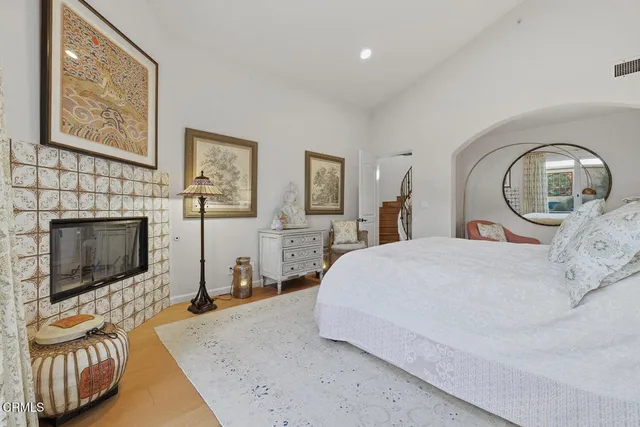 a bedroom with a bed and a fireplace