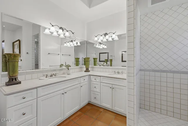 a spacious bathroom with a double vanity sink mirror and