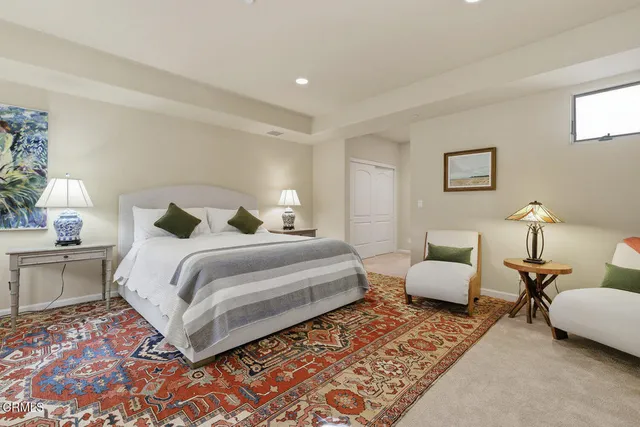 a bedroom with bed and a couch