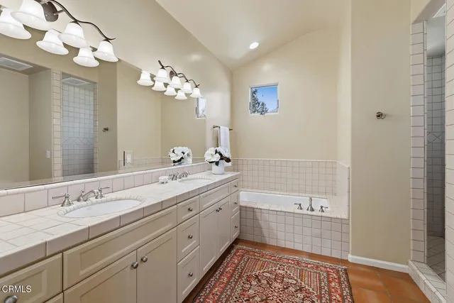 a bathroom with a double vanity sink and a mirror