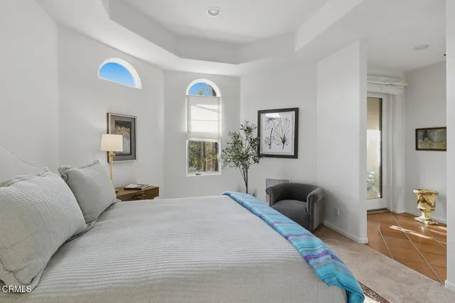 a bedroom with a bed and a couch