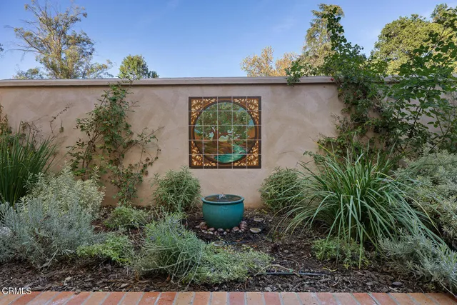 a view of a patio with table and chairs and potted plants