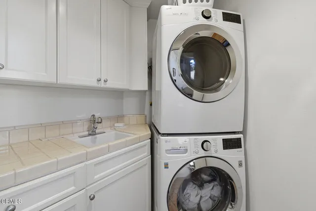 a view of a house with a yard and potted plants