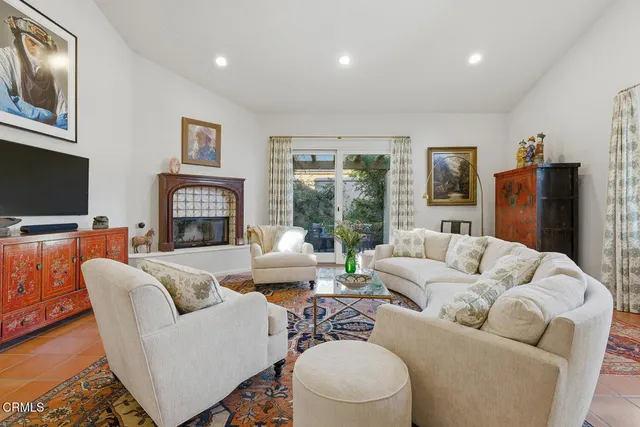 a living room with furniture fireplace and a flat screen tv
