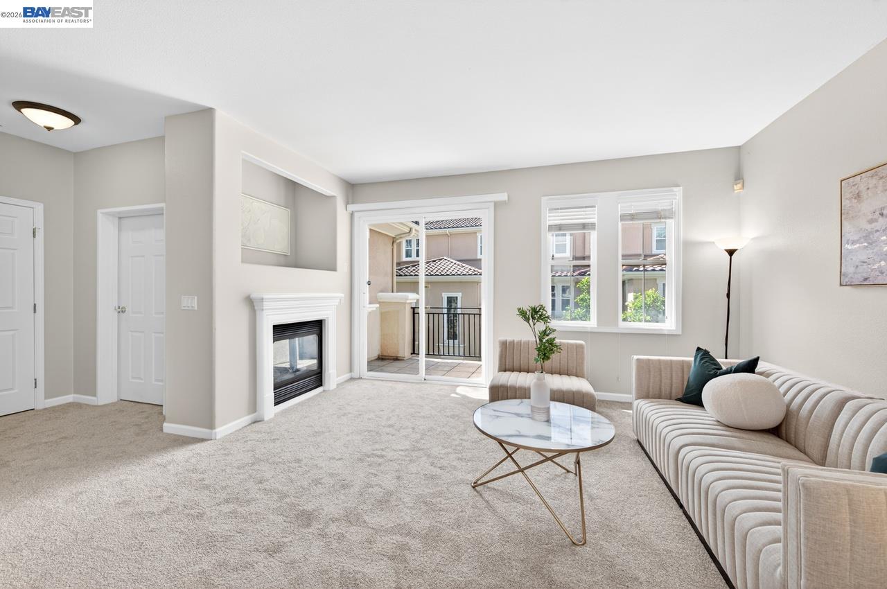3391 Monaghan Street Dublin, CA 94568 - Photo 14 of 57 a living room with furniture a fireplace and a large window
