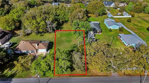an aerial view of a house with yard swimming pool and outdoor seating
