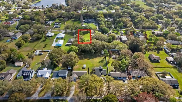 an aerial view of a houses with a yard