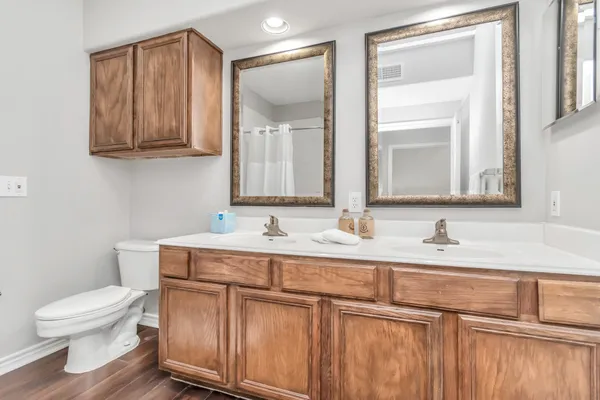a bathroom with a toilet sink and mirror