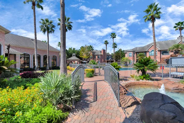 a view of a swimming pool with a patio and a yard