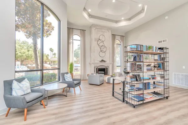 a living room with furniture and a floor to ceiling window