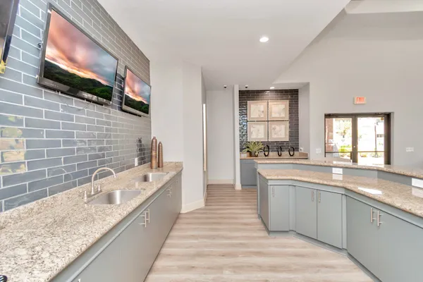 a large kitchen with kitchen island a sink stainless steel appliances and cabinets