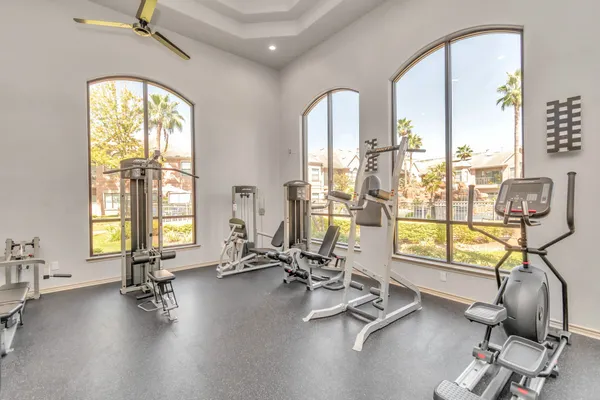 a view of a room with gym equipment and windows