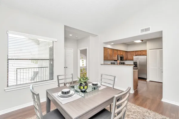 a view of a dining room with furniture and wooden floor