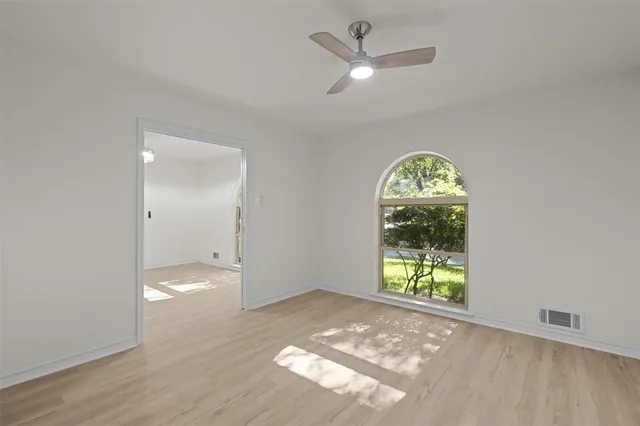 an empty room with windows and entrance