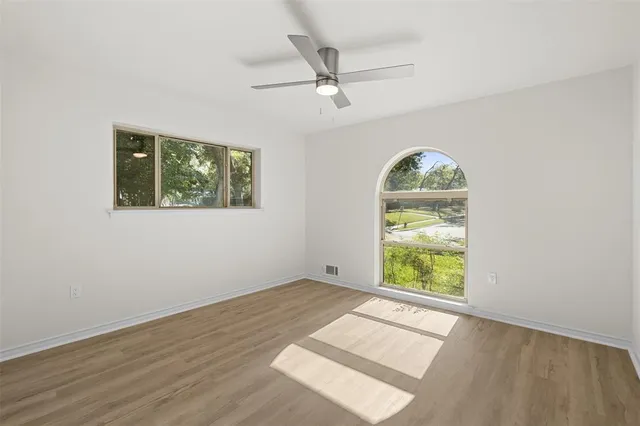 an empty room with windows and closet