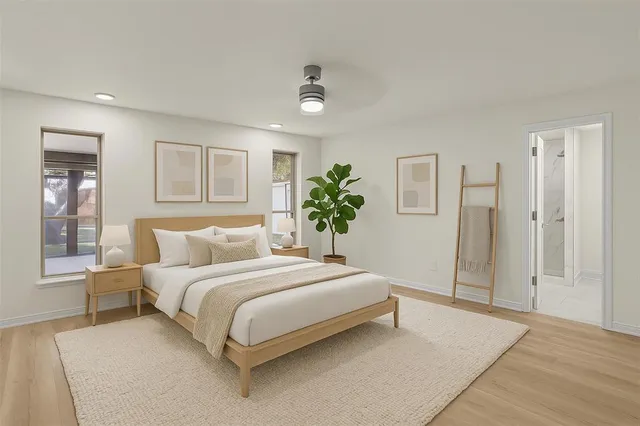 a bedroom with a large bed and a chandelier