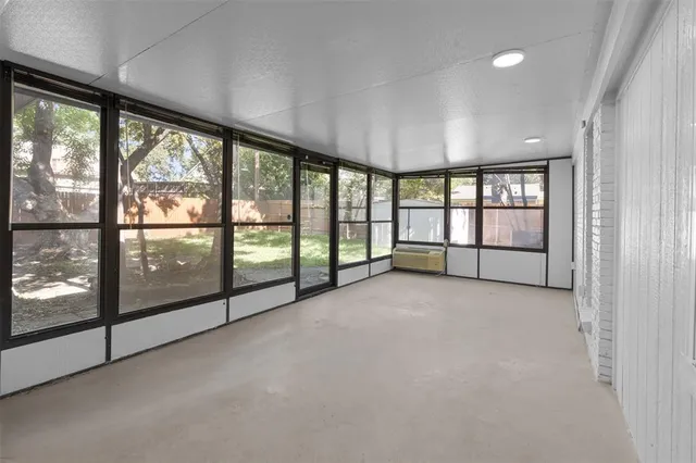 a view of an empty room with large windows