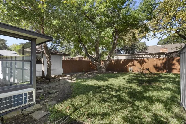 a backyard of a house with lots of green space