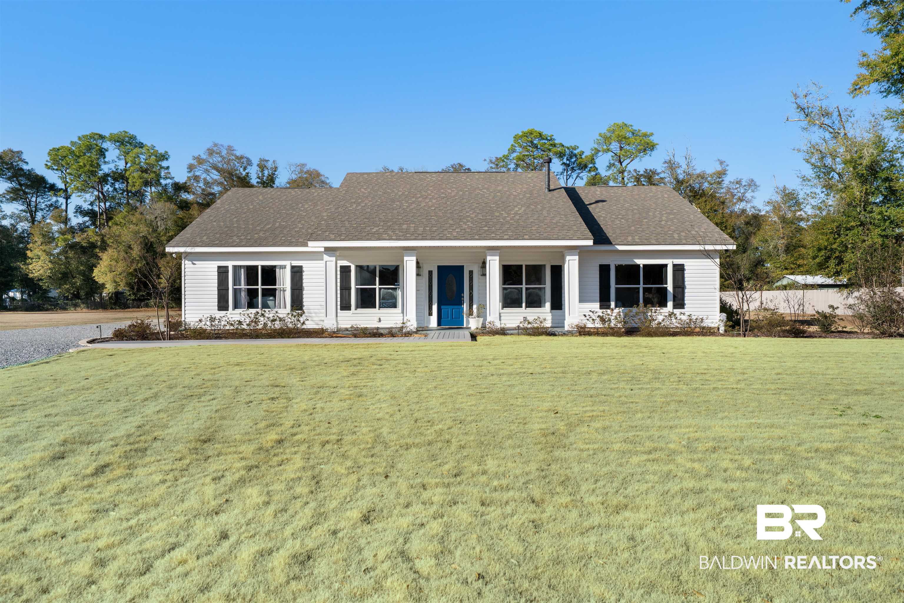 19079 Baldwin County Road 10 Foley, AL 36535 - Photo 3 of 37 Single story home with covered porch, roof with shingles, and a front lawn