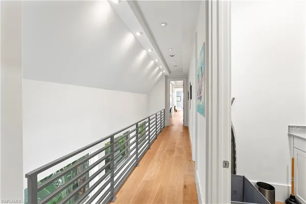 a view of a hallway with wooden floor