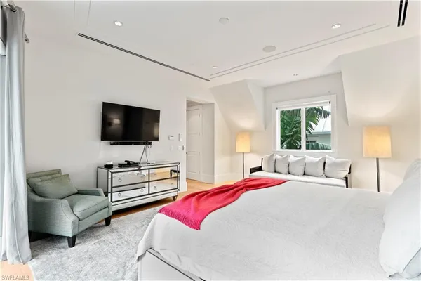 a bedroom with a bed and a flat screen tv