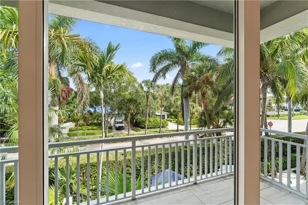 a view of a balcony with a tree