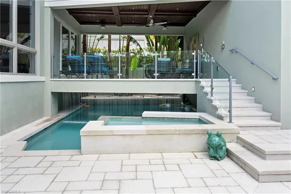a living room with furniture and flowers