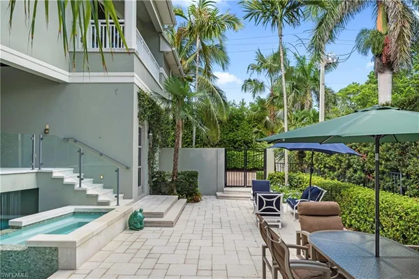 a view of backyard with outdoor seating and plants