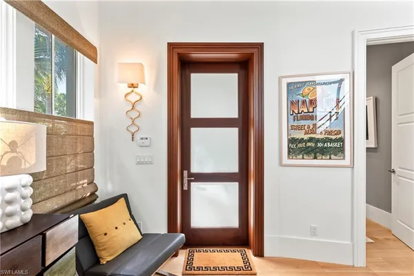 a view of wooden floor and a livingroom with windows