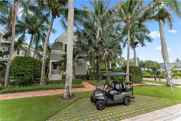 a view of a patio with table and chairs potted plants and palm trees