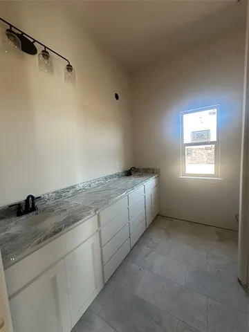 en empty room with windows and fan