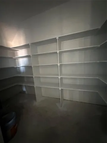 a view of a room with shelves on the wall