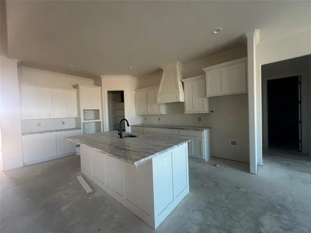 a kitchen with a sink stove and cabinets