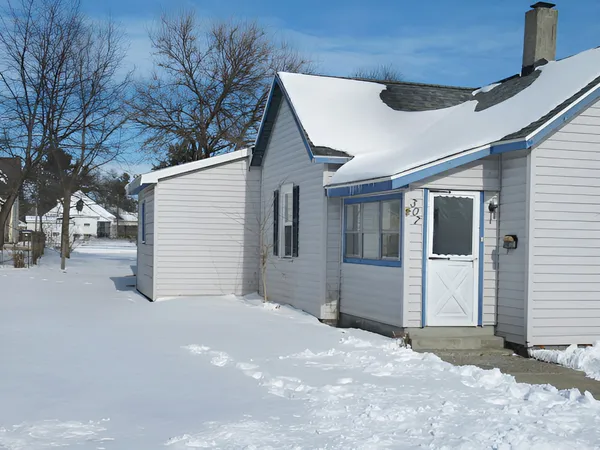 a view of a house with a snow in the yard